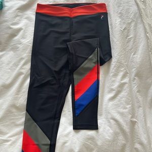 PE Nation black leggings with blue, green and red striped at bottom. Size L